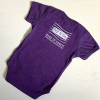 purple baby girl onesie with white Ivy & Co postage stamp logo